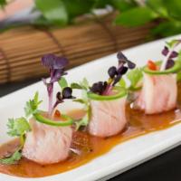 Yellowtail Jalapeño · Thinly sliced yellowtail with jalapeno slices drizzled with yuzu wasabi sauce.