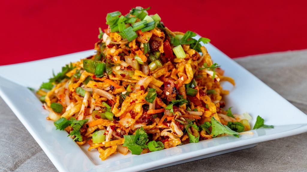 Szhwern Bhel · Crispy wonton noodles tossed with cabbage, scallions, bean, sprouts, onions, cilantro and chili peppers.