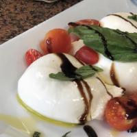 Burrata · Served with cherry tomatoes, basil, olive oil.