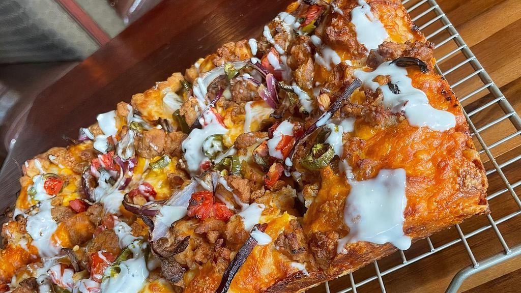Spicy Roadster (Large) · Crispy fried chicken tossed in buffalo sauce, jalapeños, seasoned diced tomatoes, red onions, aged white cheddar and mozzarella cheese blend, Romano & oregano mix. Topped off with blue cheese dressing.