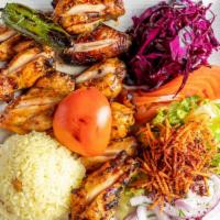 Chicken Wings · Grilled chicken wings served with rice and salad.