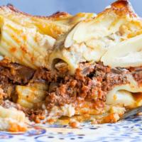 Macarona Bashamil · Baked pasta layered with ground beef in béchamel sauce.