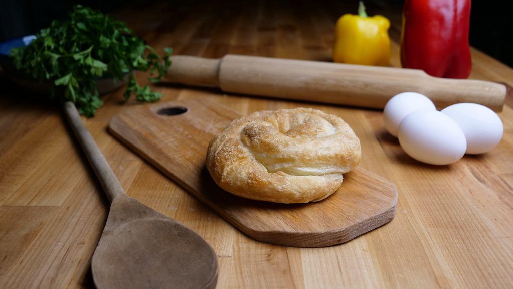 Spanakopita Pi · Hand-stretched phyllo dough stuffed with fresh spinach, imported feta cheese, and Greek herbs.
