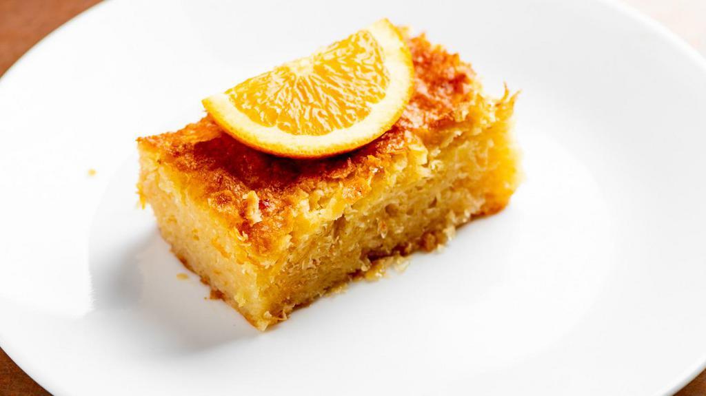 Orange “Portokalopita” Pi · A deliciously different cake and a must try! Prepared with Greek yogurt, fresh orange juice, orange zest, shredded baked phyllo, and EVOO soaked in an aromatic honey and cinnamon syrup.