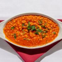 Tarka Dal · Lentils flavored with garlic and herbs.