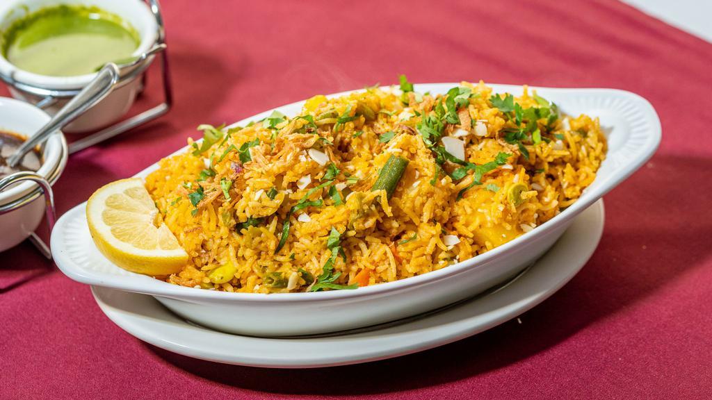 Vegetable Biryani · A royal treat basmati rice cooked with fresh vegetables and saffron sprinkled with raisins and nuts.