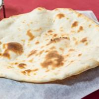 Naan · Teardrop-shaped white bread baked by slapping it quickly on the sides of the tandoor served ...