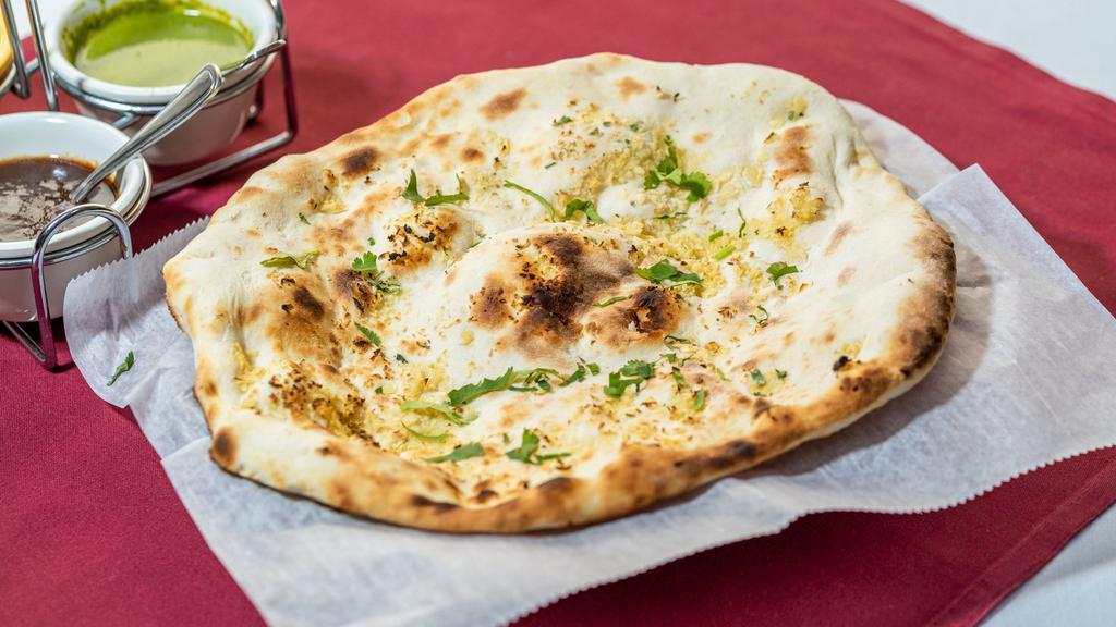 Garlic Naan · Light bread made with fresh garlic, herbs and cilantro.