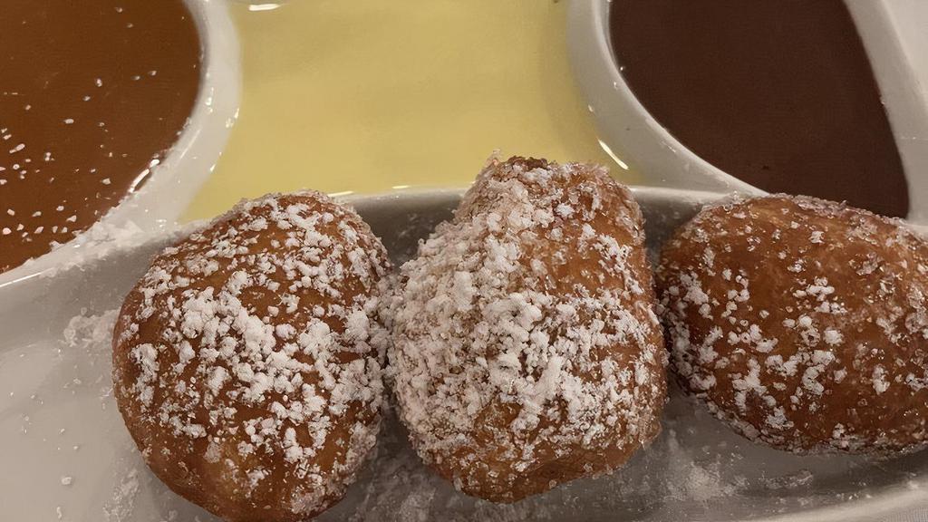 Beignets · French style donuts made to order, filled with raspberry jam, accompanied by crème anglaise, caramel sauce, chocolate sauce.