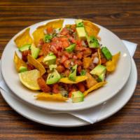 Chifrijo · Rice and red beans mixed with fried pork, avocado and pico de gallo with chips.