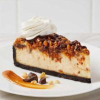Candy Bar Cheesecake · Creamy cheesecake blended with Butterfingers®, Reese's®, and Snickers® then swirled with car...