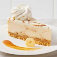 Bananas Foster Cheesecake · Banana cheesecake swirled with buttery caramel, topped with white chocolate mousse and a car...