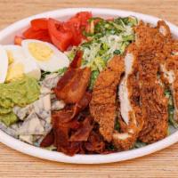 Cobb Salad · Crispy chicken, diced tomatoes, bacon, smashed avocado, boiled egg, lettuce, blue cheese, ra...