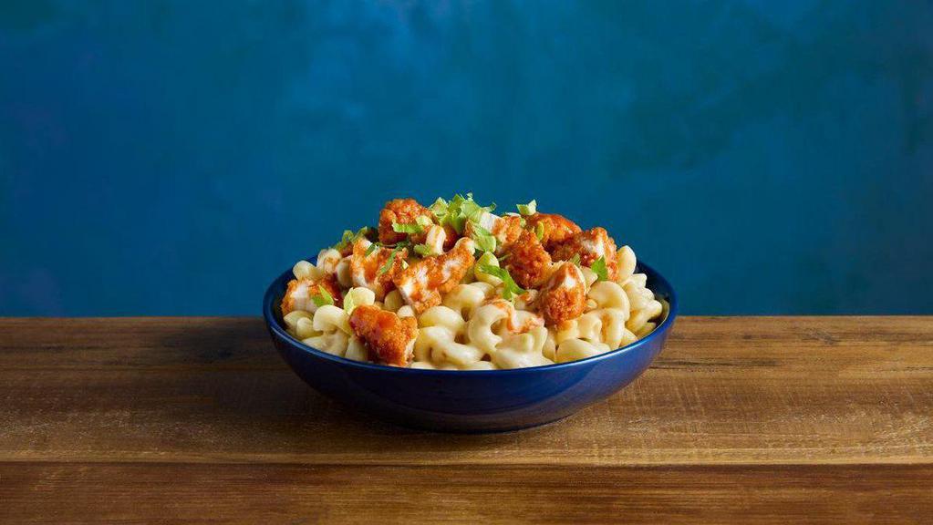 Buffalo 3-Alarm Chicken Kraft® Mac & Cheese · KRAFT White Cheddar Mac & Cheese topped with crispy chicken tender pieces glazed with TAPATIO® Hot Sauce and garnished with a touch of celery greens