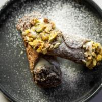 Cannoli · two house made ricotta filled cannolis, dipped in chocolate chips and pistachios