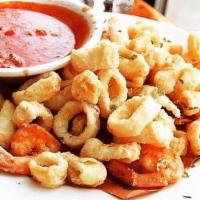 Fritto Misto Di Pesce · Fried calamari and shrimps served with a side of tomato sauce.