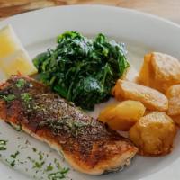 Salmone Croccante · Crispy roasted salmon with sauteed spinach and roasted potatoes.