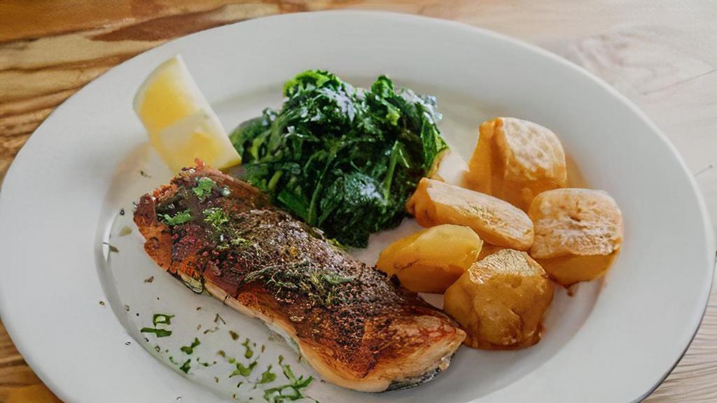 Salmone Croccante · Crispy roasted salmon with sauteed spinach and roasted potatoes.
