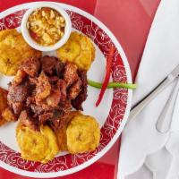 Griot · Succulent pieces of deep fried pork served sizzling creole sauce and pikliz (pickled veggie ...