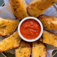 Garlic Bread · Rustic Italian bread toasted with garlic parmesan butter and served with marinara sauce.