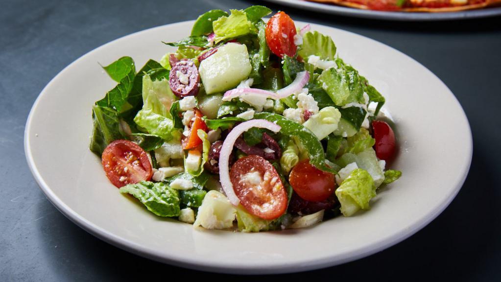 Greek Salad · romaine lettuce, kalamata olives, feta cheese, cucumbers, bell peppers, sweet red onions, tomatoes with olive oil, and white balsamic vinegar