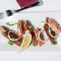 Lamb Seekh Kebab · Minced lamb marinated with aromatic herbs, fresh ginger, wrapped around skewer and roasted i...