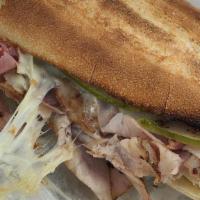 El Cubano Sandwich · Hot. Ham, roast pork, Swiss cheese, pickle and mustard. Served on hero bread.