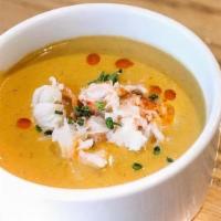 Lobster Bisque · Creamy lobster bisque topped with lobster morsels and chives.
