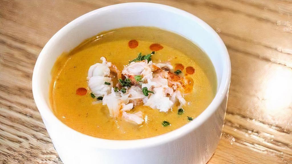 Lobster Bisque · Creamy lobster bisque topped with lobster morsels and chives.