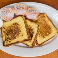 French Toast · Three Slices of Battered, Grilled Challah French Toast

Served with Syrup & Butter