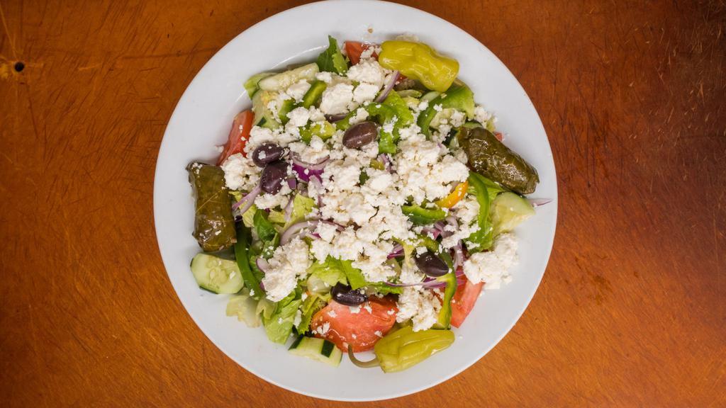 Greek Salad · Fresh Greens, Feta Cheese, Grape Leaves & Mediterranean Garnish

Served with House-made Greek Dressing