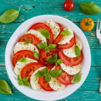 Caprese Salad · Fresh mozzarella, vine-ripened tomato and fresh basil with your choice of dressing.