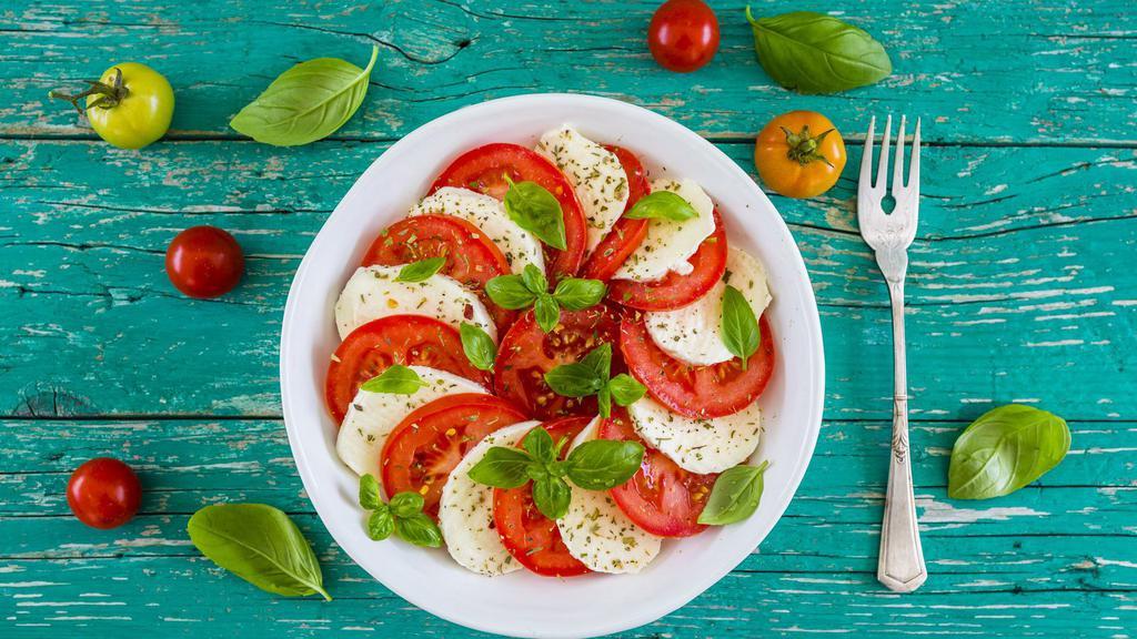 Caprese Salad · Fresh mozzarella, vine-ripened tomato and fresh basil with your choice of dressing.