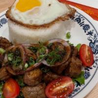 Shaken Steak And Rice · Sauteed cubed steak, sunny side up eggs, onions, scallions and cilantro served with white rice