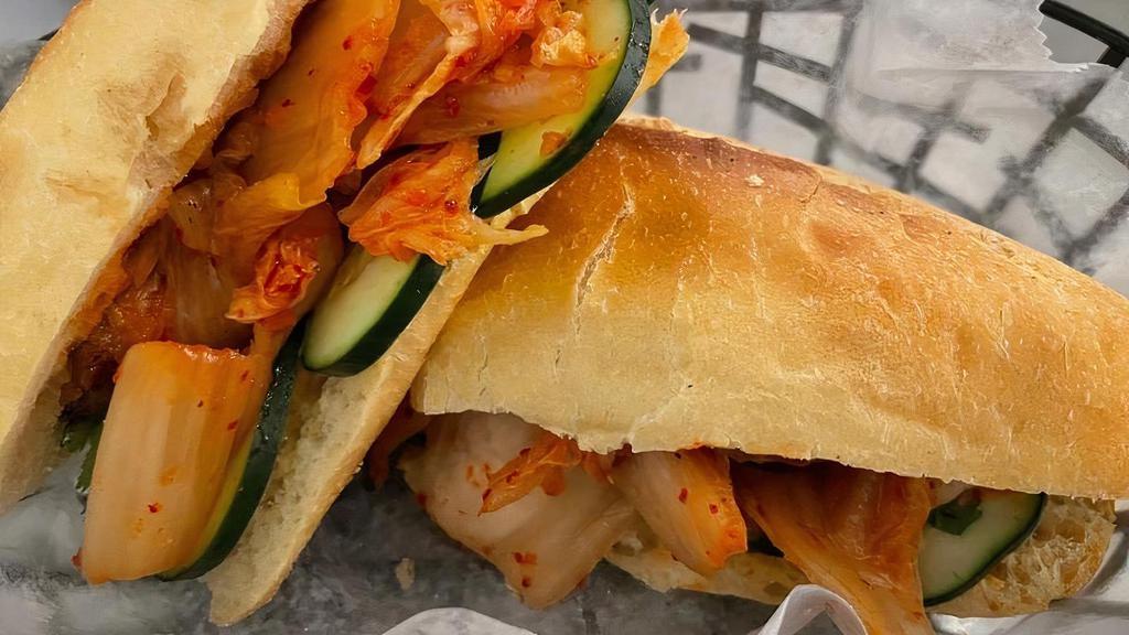 Banh Mi: Spicy Chicken Curry · Vietnamese sandwich on a toasted French baguette with pickled carrot, cucumber, and cilantro. With chicken in creamy spicy curry sauce on the side