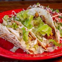 Lunch Tres Puercos Taco · Two tacos and a side salad. tacos include: shredded pork, chorizo, bacon, caramelized onions...