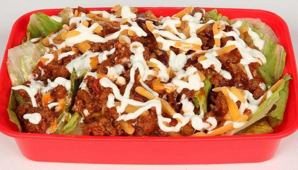 Lean Turkey Taco Salad · Turkey chili, romaine, spinach, red beans, reduced fat cheddar, salsa, tomatoes, scallions, fat free sour cream.