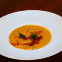 Dal Tadka · Simmered yellow lentils tempered with ginger, garlic, and mustard seeds.