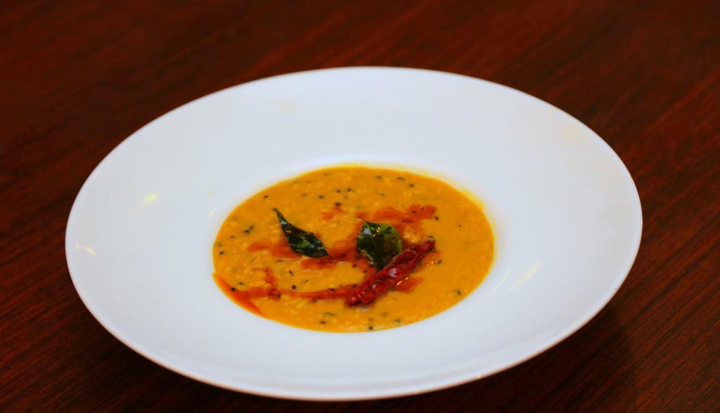 Dal Tadka · Simmered yellow lentils tempered with ginger, garlic, and mustard seeds.