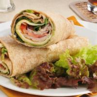 Turkey Club Wrap · Delicious, homemade wrap prepared with Golden, oven-roasted turkey with bacon, lettuce, toma...