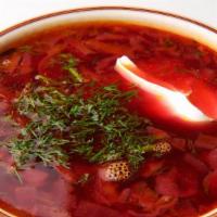 Borsh Soup · Russia's signature soup with beets & cabbage, topped with dill sour cream & garlic.