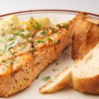 Pan-Seared Salmon · Served with Leeks, baked bread, fingerling potatoes, and creamy sauce.