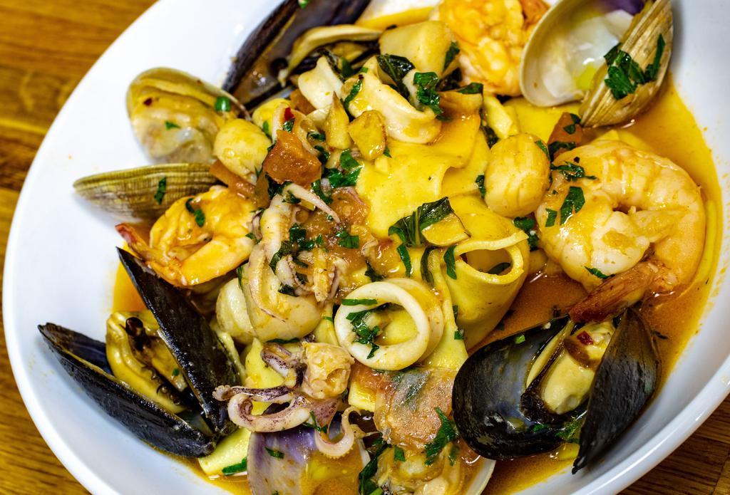 Pappardelle Di Mare · Mixed seafood (mussels, clams, shrimp, calamari, baby scallops) in a garlic, white wine tomato sauce.