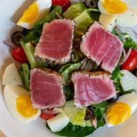 Niçoise Salad · Grilled tuna, lettuce, olives, hard-boiled egg, tomato, onion, and potatoes.