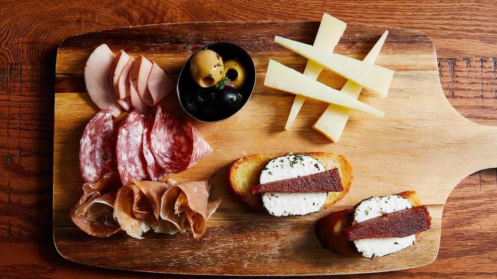 Charcuterie Board · Goat Cheese & Membrillo Crostinis, Prosciutto di Parma, Mortadella, Soppressata, Manchego, Marinated Olives