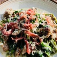 Spinach Fettuccine & Italian Sausage · Broccoli di rabe, Sage Parmesan Cream Sauce, Topped with Prosciutto di Parma