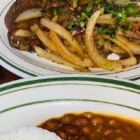Bistec Encebollado · Beef with onions served with rice, beans, and sweet plantains.