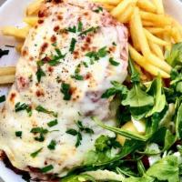 Chicken Parmy · Crumbed chicken breast, pomodoro sauce, mozzarella, ham off the bone, fries, fennel salad.