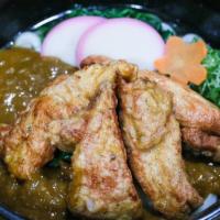 Karaage Curry Udon · Fish broth and udon topped with chicken karaage curry, seasonal veggie, fish cake, and scall...