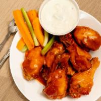 Buffalo Chicken Wings · Served with bleu cheese dressing and celery sticks.